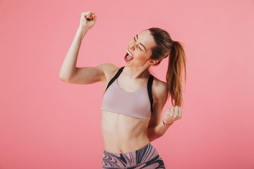 Image of sportswoman rejoices with closed eyes and open mouth
