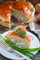 Closed yeast dough cake with fish, selective focus