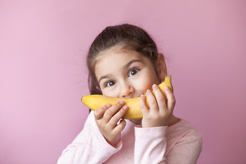 Little girl with yellow banana like smile