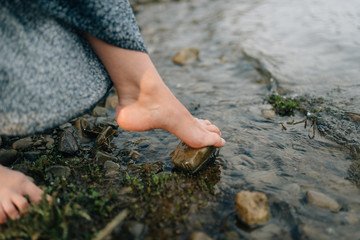 jumping over rocks over cold water in a river
