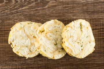 Calsbad bread dumpling top view three slices isolated on brown wood background fresh steamed.
