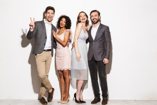Group of happy well dressed multiracial people standing