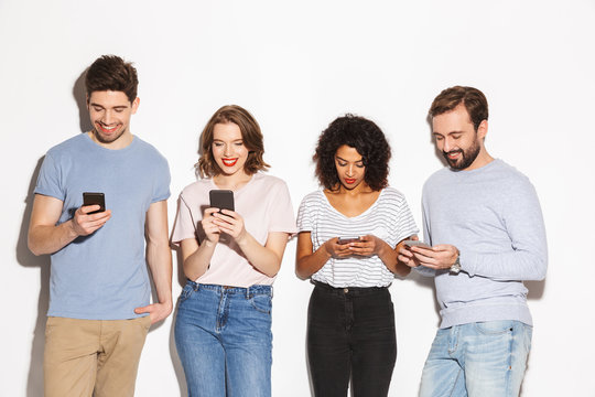 Group of happy multiracial people using mobile phones