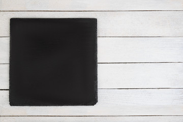 black slate board on  wooden background