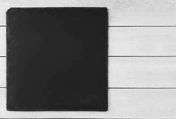 black slate board on  wooden background