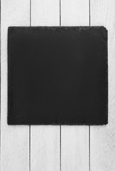 black slate board on  wooden background