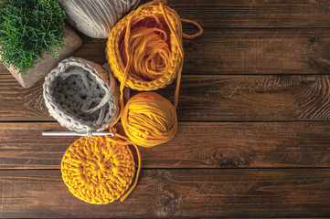 Knitting. Home hobby. Wabi-Sabi-style composition on a wooden background. Top view. Easy vintage toning