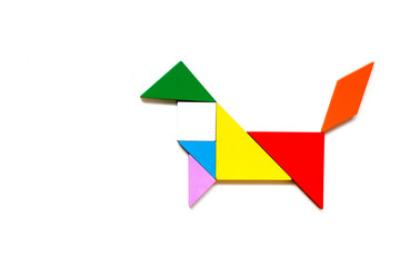 Color wood tangram puzzle in dog shape on white background
