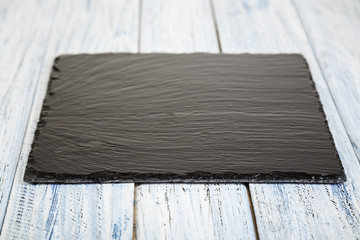 black slate board on  wooden background