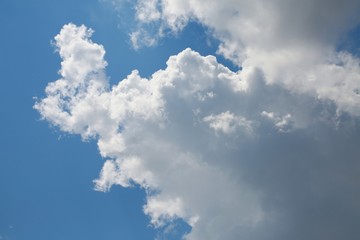 Fluffy Billowy Cumulus Clouds Backlit by the Sun in the Blue Summer Sky in Florida