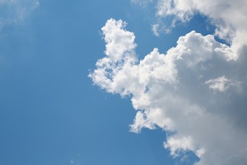 Fluffy Billowy Cumulus Clouds Backlit by the Sun in the Blue Summer Sky in Florida