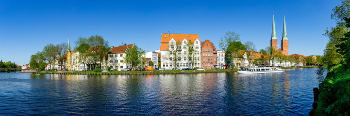 Lübeck, Dom district in early summer with River Trave and excursion boat