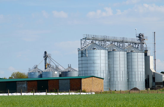 Silos for feed. A feed mixer in a large farm.