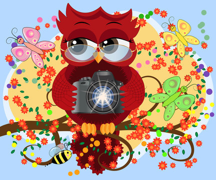 A red sweet owl in glasses and with a camera sits on a flowering branch of a tree. Photo business, photographer, vocation, profession