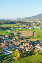 Aerial view of a beautiful landscape with traditional houses, green meadows, Gruyeres, Switzerland