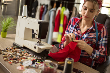  fashion designer woman sewing for new collection in her workshop