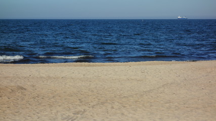 Seascape with a lone freighter on the horizon