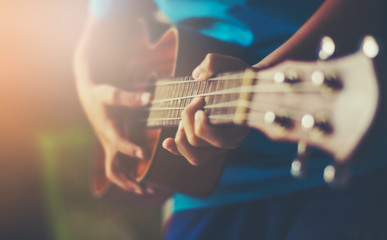 Fototapeta na wymiar Hands playing acoustic guitar ukulele 