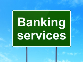 Currency concept: Banking Services on green road highway sign, clear blue sky background, 3D rendering