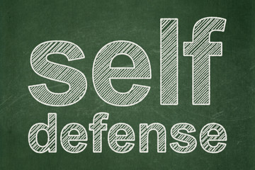 Protection concept: text Self Defense on Green chalkboard background