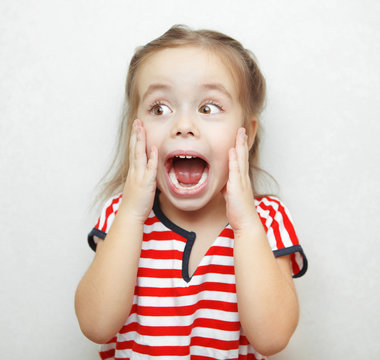 Funny little girl taken aback by great surprise