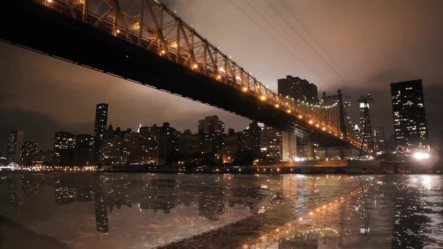Magnificent low angle time lapse panorama view on night light illumination on modern Manhattan Brooklyn Bridge cityscape