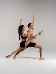 Modern ballet dancer couple in black form performing art element with empty copy space background,...