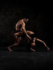 Modern ballet dancer couple in black form performing art dance element with empty copy space background, izolated