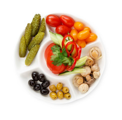 Plate of cold appetizers isolated on white background