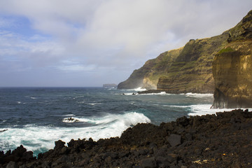 Fototapeta na wymiar View of cliffs and seashore in volcanic area