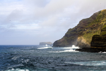 View of cliffs and seashore in Azores volcanic coastline
