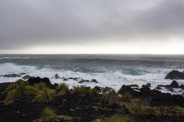 Obraz premium Volcanic coastline Landscape. Ocean and black volcanic rock formations 