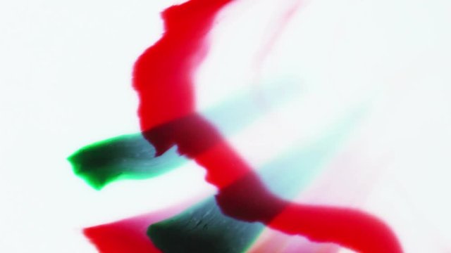 Red and green shapes pushed up by a rising arc of dark green