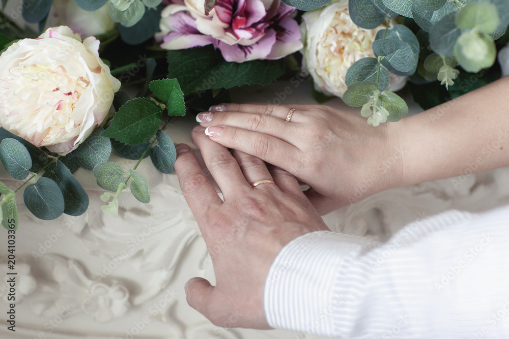 Wall mural hands of newlyweds with wedding rings