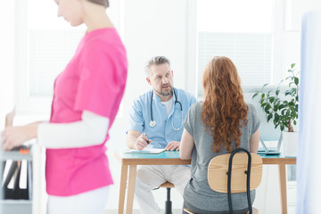 Sick woman talking with gynecologist