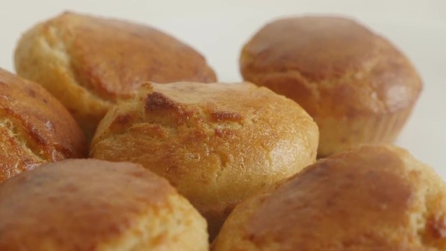 Shallow DOF cornbread prepared as a muffin slow tilt footage - Tasty cornmeal on white plate close-up