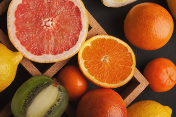 Variety of ripe citruses on gray background