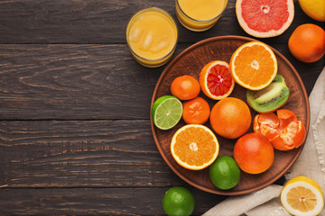 Obraz na płótnie Canvas Variety of ripe citruses on wooden background