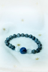 lapis lazuli bead and Labradorite Crystal lucky stone bracelet bead on white towel background.fashion with believe in Add charm,property, healthy in wonderful life.