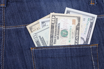 A few US dollar bills sticking out of the back pocket of his trousers