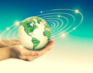 Ecological concept of the environment with the cultivation of trees on the ground in the hands. Planet Earth. Physical globe of the earth. Elements of this image furnished by NASA. 3D illustration