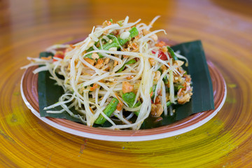 SOM-TAM, Thai delicious raw papaya salad with unique taste hot and spicy, this dish with tomato and crab. Papaya salad with red chili.
