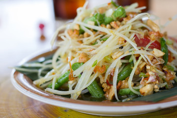 SOM-TAM, Thai delicious raw papaya salad with unique taste hot and spicy, this dish with tomato and crab. Papaya salad with red chili.