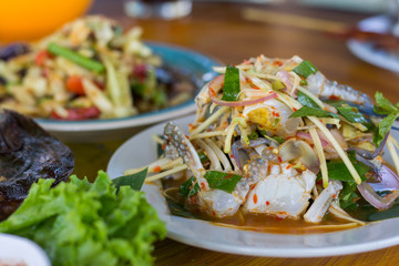 SOM-TAM, Thai delicious raw papaya salad with unique taste hot and spicy, this dish with tomato and crab. Papaya salad with red chili.