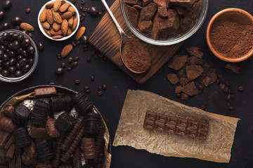 Top view on chocolate and nuts on black background