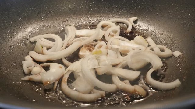 Wok with Allium cepa vegetable footage - Frying of bulb onion in hot oil close-up