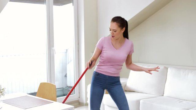 people, housework and housekeeping concept - happy woman or housewife with mop cleaning floor and dancing at home