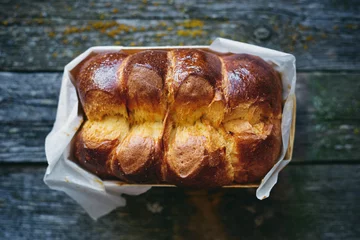 Fotobehang Delicious homemade organic brioche bread on wooden rustic table top view  © aleksakarina