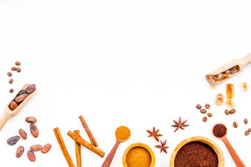 Seasoning for cooking desserts. Cinnamon, cocoa, badian, coffee on white background top view copy space