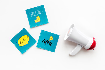 Socail media announcements concept. Megaphone near social media icons on white background top view